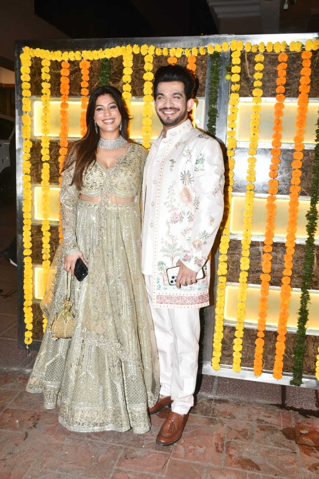 Arjun Bijlani who has won Rise and Fall came with his wife, Neha Swami. He wore a cream coloured sherwani with embroidery, while Neha opted for bright golden embellished lehenga which she paired with heavy diamond jewellery.